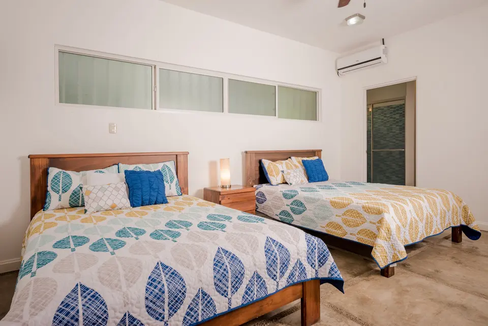 Poolside bedroom with two beds